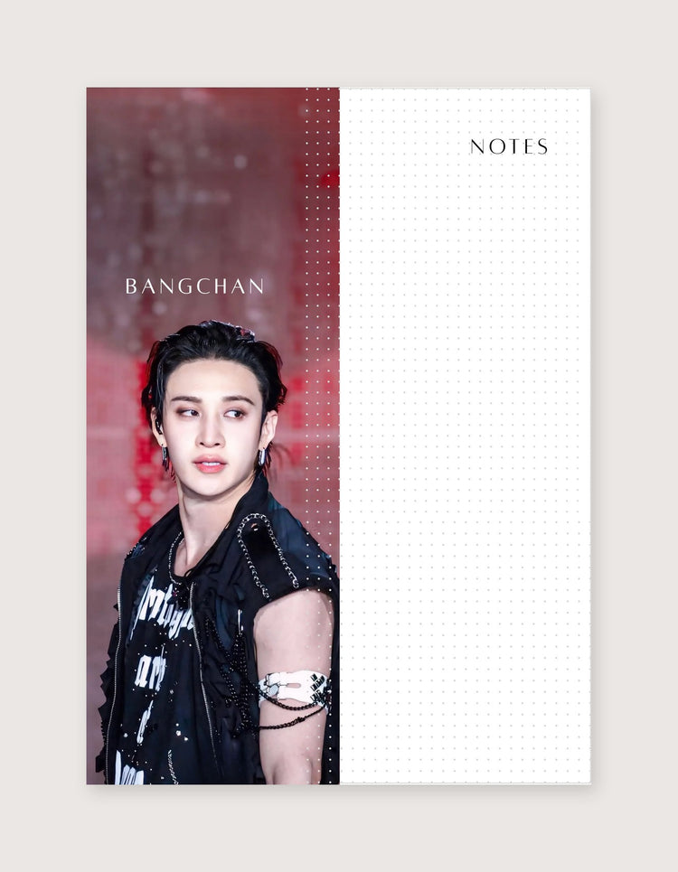 A vertical planner-style note card or memo pad with a split design: the left half shows a portrait photo of Bangchan against a red-toned background with his name printed in white, and the right half is a white dotted grid area labeled NOTES.