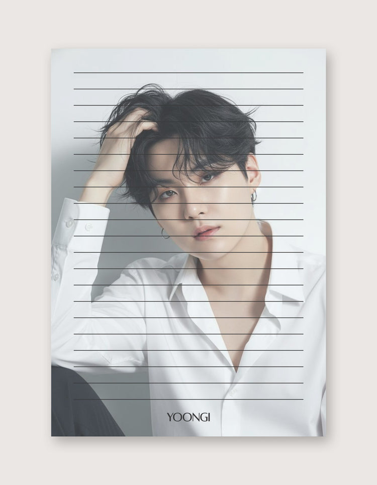 A vertical art print featuring a portrait of Yoongi from BTS, styled with horizontal lined notebook paper overlay graphics. The print is displayed against a solid, warm off-white background.
