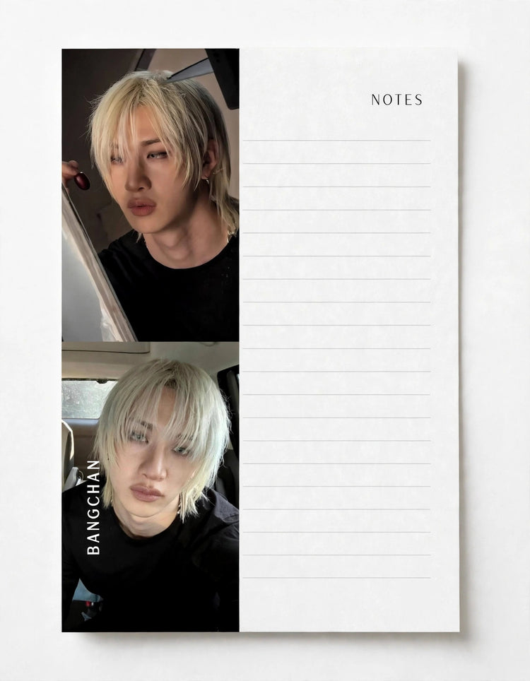 A white lined notepad with the word NOTES printed at the top right, shown on a light gray background. The left side of the pad features two stacked portrait photos of a person with platinum blonde hair wearing a black shirt, with the name BANGCHAN printed vertically in white text.