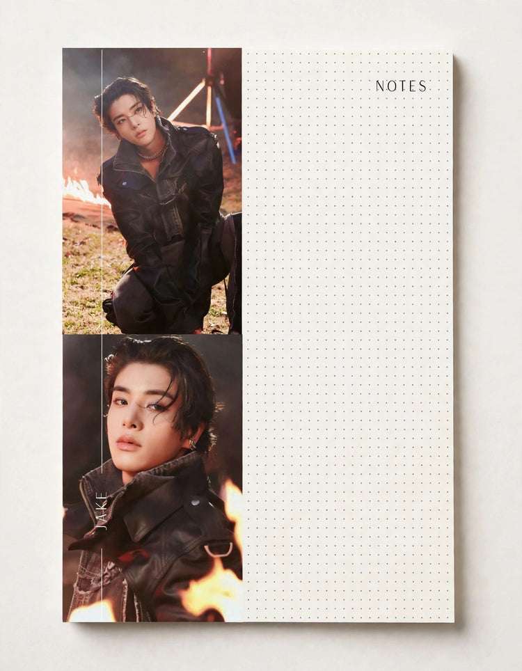 A personalized dot-grid notebook with two printed photos of a man in black clothing and flames, placed on a light beige surface next to the word 'NOTES'.