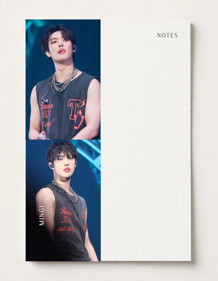 A square stationery note pad with a clean white grid writing area on the right and two vertical portrait photos of a man on the left, printed on a light neutral background.