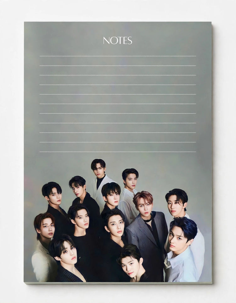 A vertical notebook or memo pad cover with the word NOTES at the top and lined writing space above a group photo of multiple young men at the bottom, shown against a plain light background.