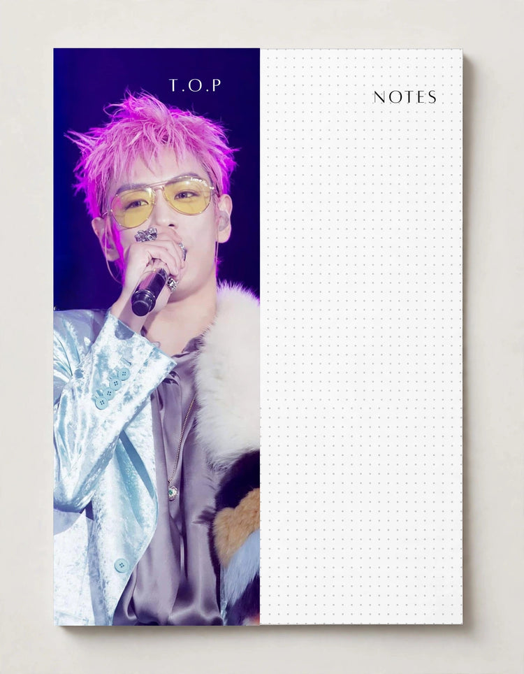 man with pink hair holding micro phone, with a white space to the right for NOTES